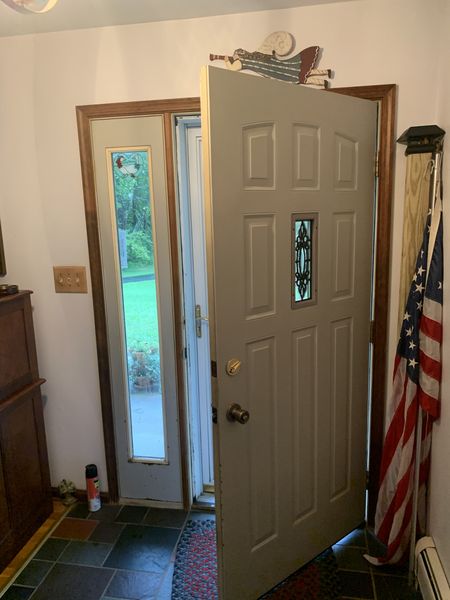 Panel entry door with a decorative glass insert and a sidelight, shown open from inside, installed by David