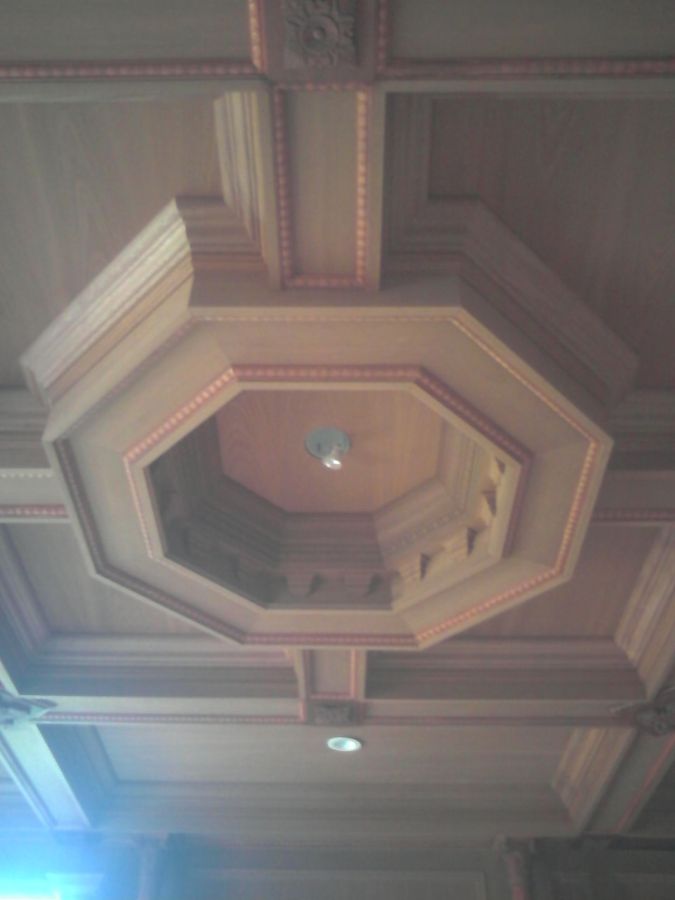 Wood coffered ceiling with an octagonal recessed center framed in layered trim and beaded molding, with a light fixture in the middle, installed by David